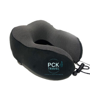 A close up image of a black and gray memory foam travel pillow with a gradient PCK Travel Logo.