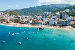 Puerto Vallarta beach with boats and waterfront buildings