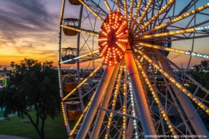 Ferris wheel illuminated at sunset in Anaheim, California, showcasing the city’s entertainment district and Southern California evening skyline.