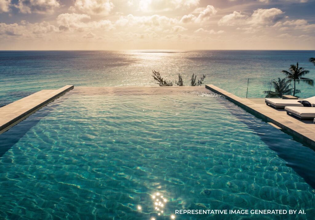Infinity pool reflecting sunlight with a calm ocean horizon in the background