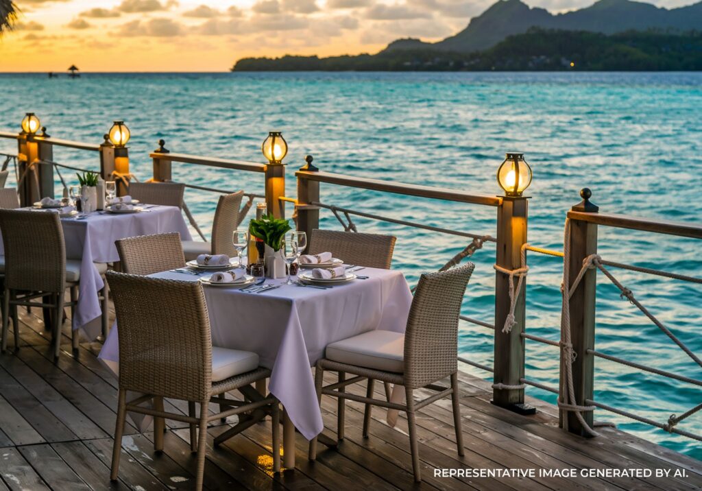 Lanterns illuminating a waterfront dining table at dusk in Bora Bora.
