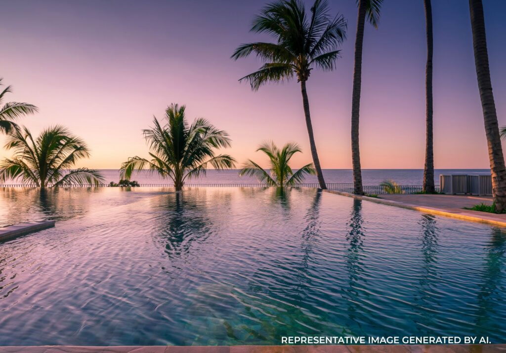 Infinity pool with palm trees overlooking the ocean at sunset in Jamaica