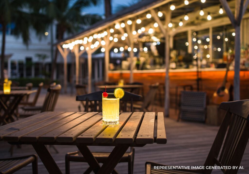 A scenic outdoor dining patio in Key West with palm trees and warm lighting.