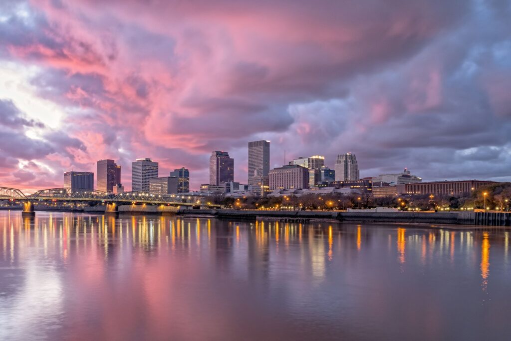 Panoramic New Orleans skyline glowing at sunset