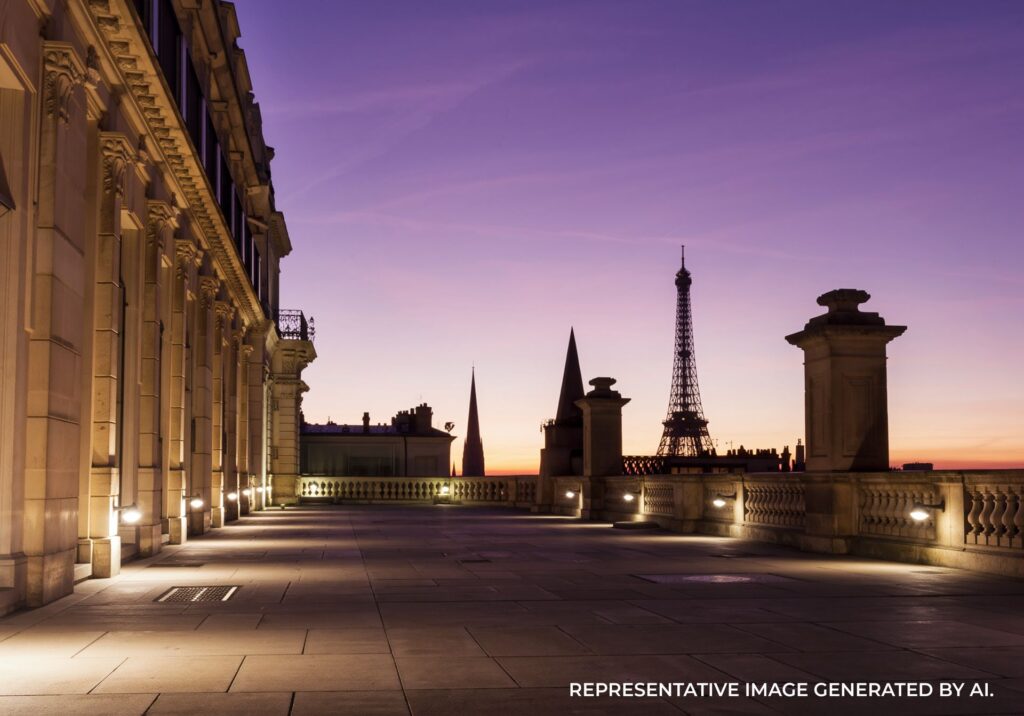 Sunset over Place de la Concorde in Paris with historic buildings and city lights reflecting on wet pavement.