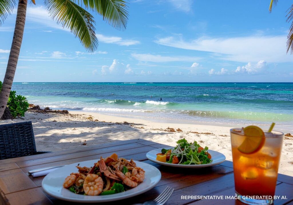 Outdoor dining table overlooking the beach with seafood and salad plates in Playa del Carmen.