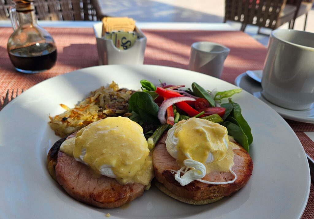 Eggs Benedict served outdoors with ocean views at a Puerto Vallarta restaurant