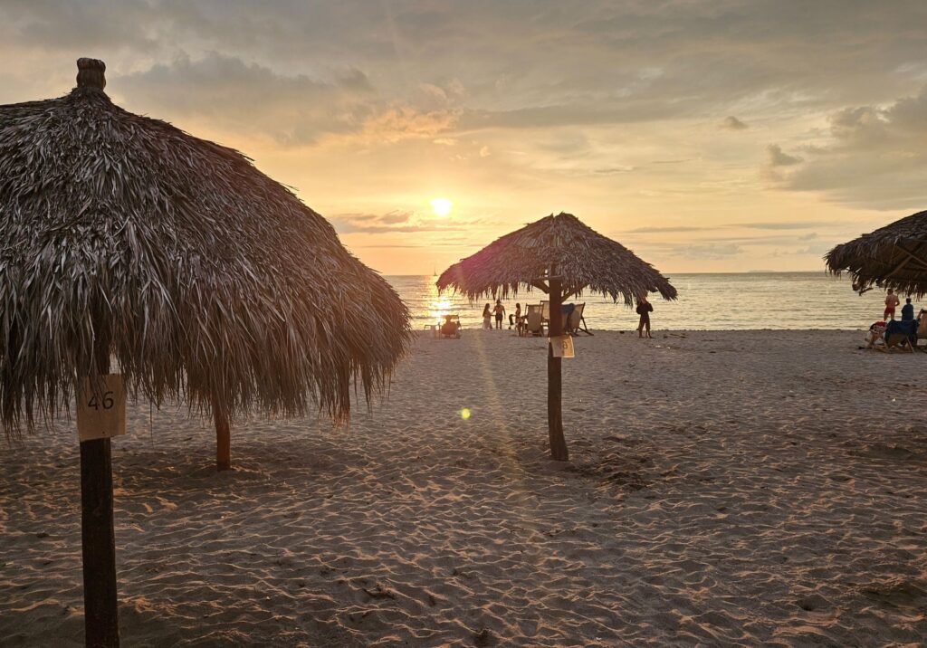Palapa hut on the sand during a warm sunset in Puerto Vallarta