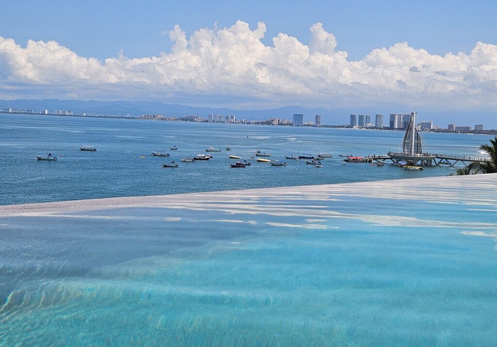 Aerial view of Puerto Vallarta’s coastline with blue water and the city skyline in the distance