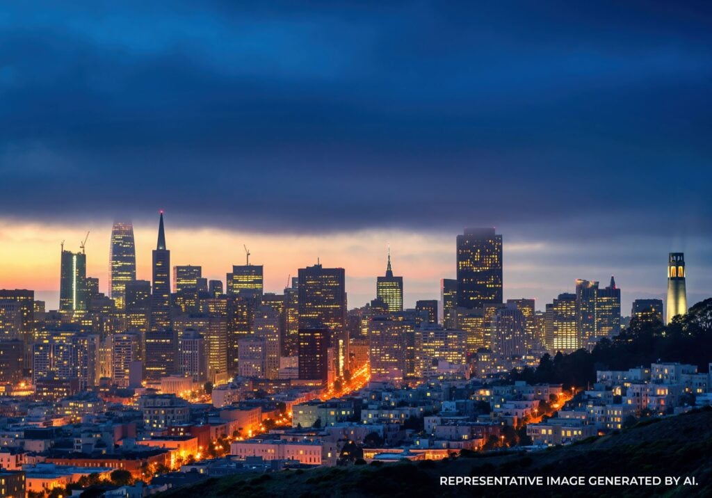 The San Francisco skyline glows under fading twilight light, overlooking the bay.