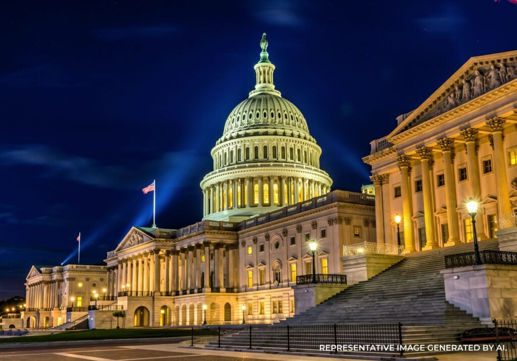 Night view of the U.S. Capitol Building illuminated against a deep blue sky