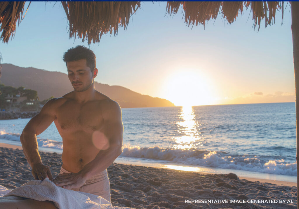 Shirtless male massage therapist providing a beachside massage at sunset in Puerto Vallarta.