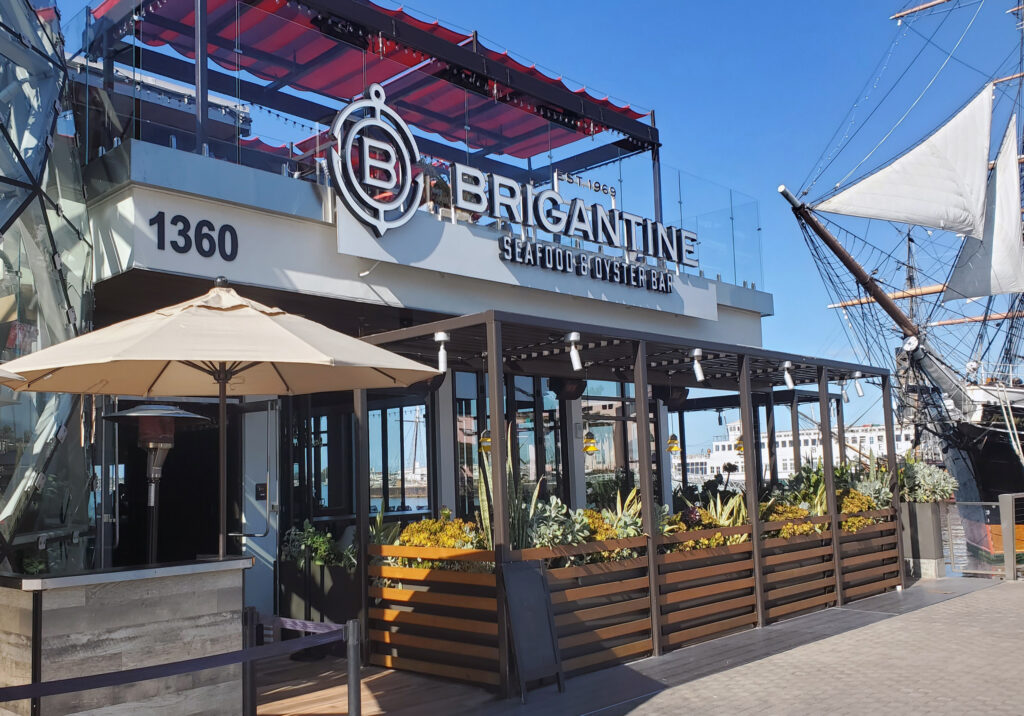 Exterior of Brigantine restaurant in San Diego with nautical themed design and outdoor seating