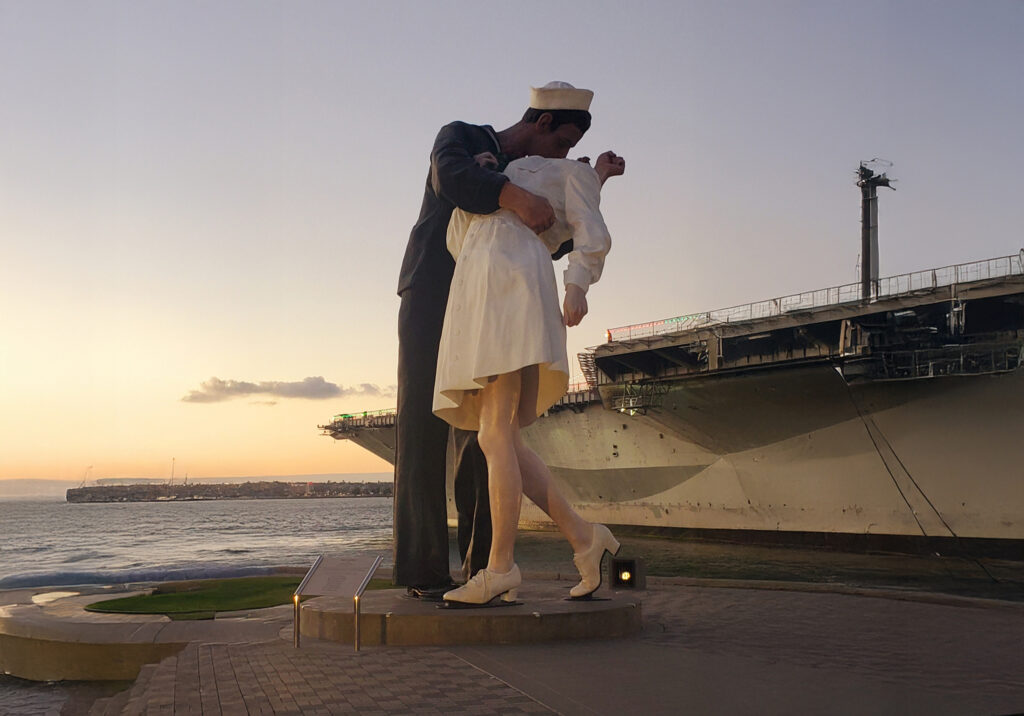 View of the Unconditional Surrender statue near the USS Midway Museum at sunset in San Diego.