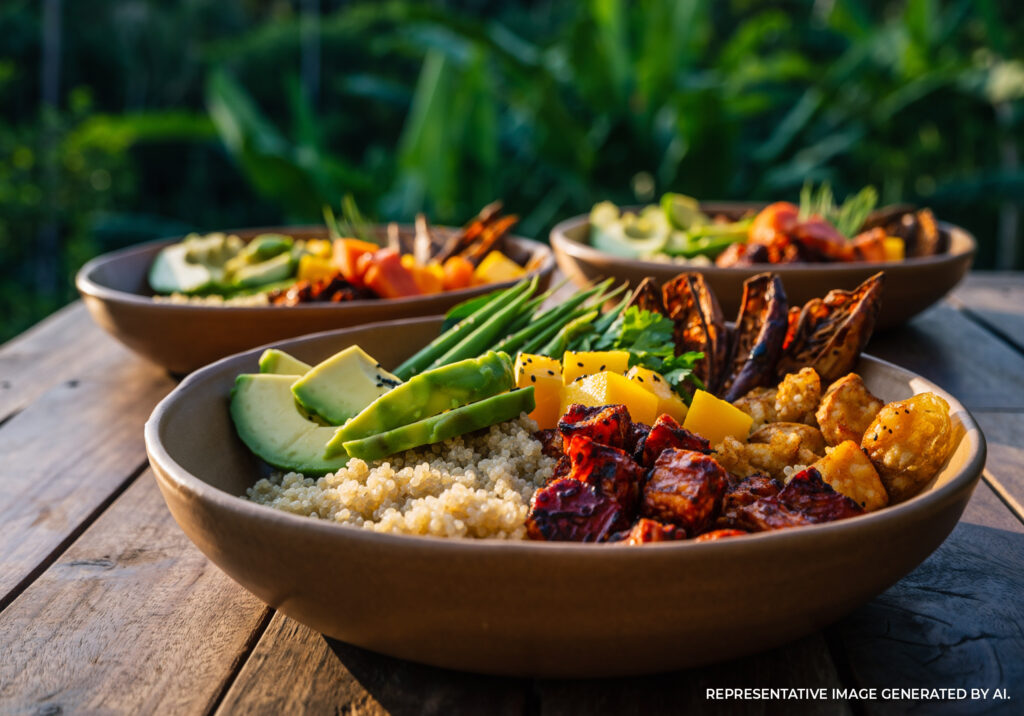 Gourmet bowl with fresh seafood, roasted vegetables, and lime served outdoors in Tulum Mexico