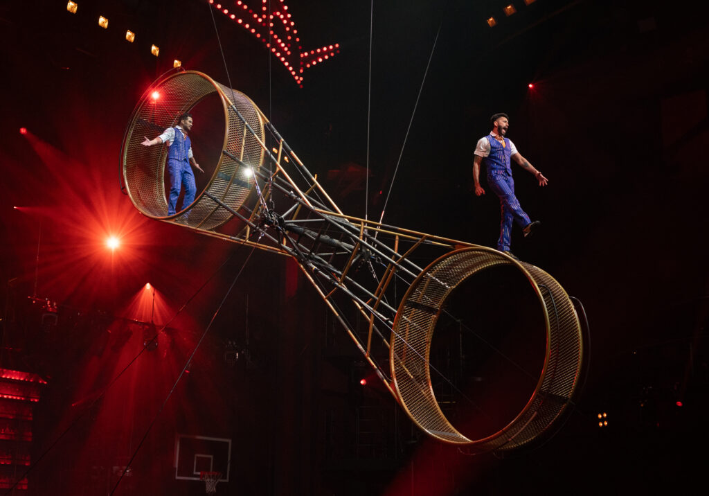 Mad Apple by Cirque du Soleil performers balancing and performing acrobatics on the Wheel of Death during a live Las Vegas show
