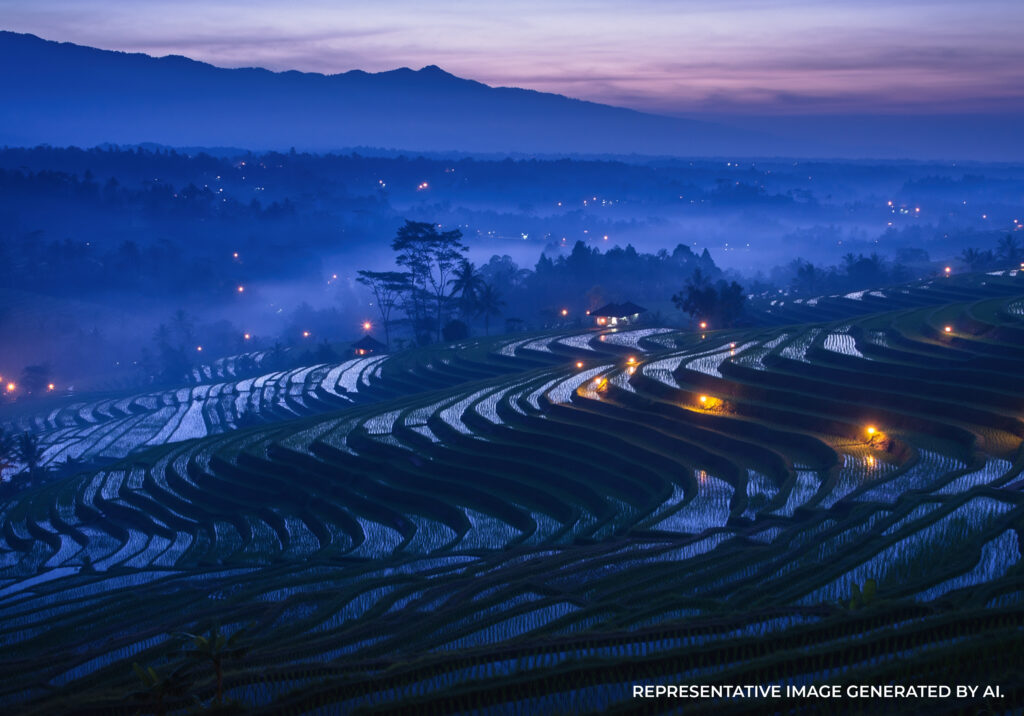 AI generated image of terraced rice fields illuminated at dusk, with winding roads and soft blue evening tones.