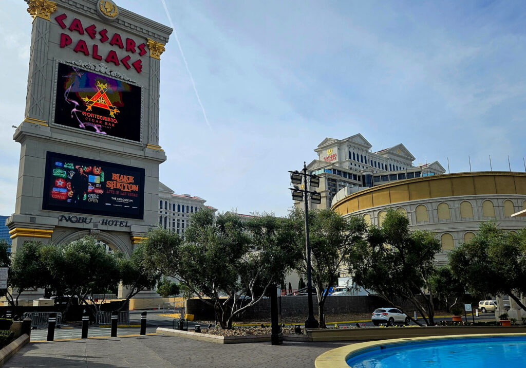 Caesars Palace Las Vegas exterior showing the iconic resort sign, Nobu Hotel entrance, and surrounding Strip architecture on a clear day.