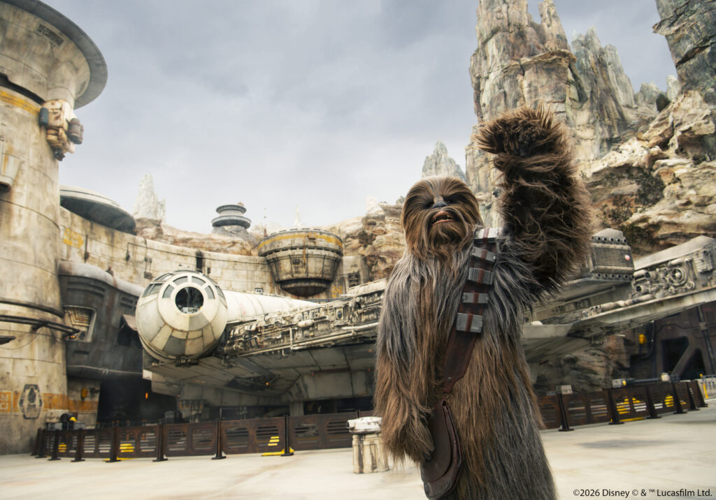 Chewbacca standing near the Millennium Falcon at Star Wars Galaxy’s Edge in Disneyland