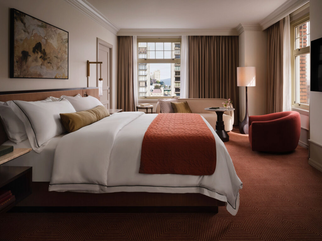 Elegant guest room at The Huntington Hotel with city view and soft natural light
