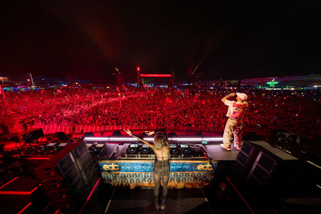 Electric Daisy Carnival Las Vegas crowd with large stage and red lighting at night