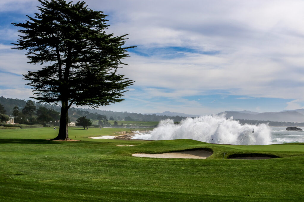 Pebble Beach Golf Links fairway and bunker overlooking the Pacific Ocean with coastal scenery.