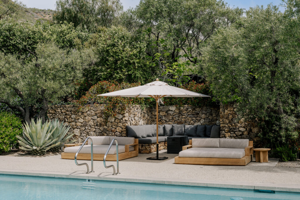 Secluded pool lounge area surrounded by greenery at The Ranch
