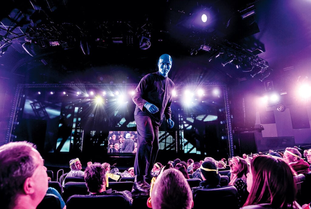 Blue Man performer interacting with the audience during a live Blue Man Group performance at Luxor Las Vegas.