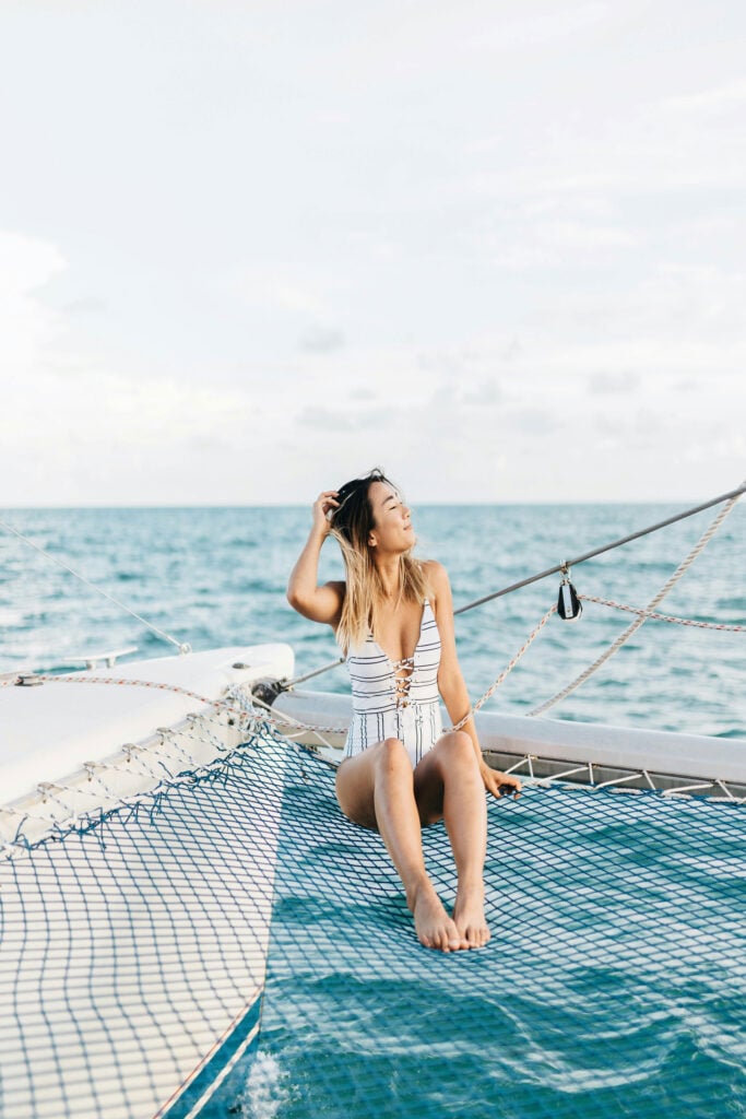 Traveler relaxing aboard a sailboat while enjoying ocean views