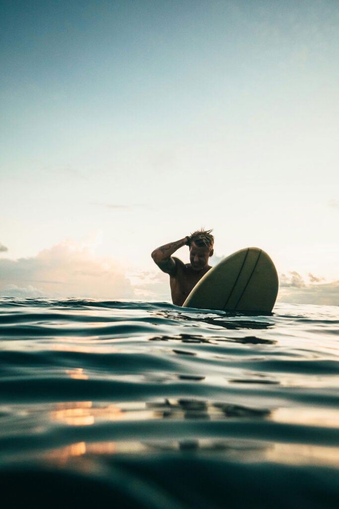 SSurfer resting in the ocean during a peaceful coastal surf session