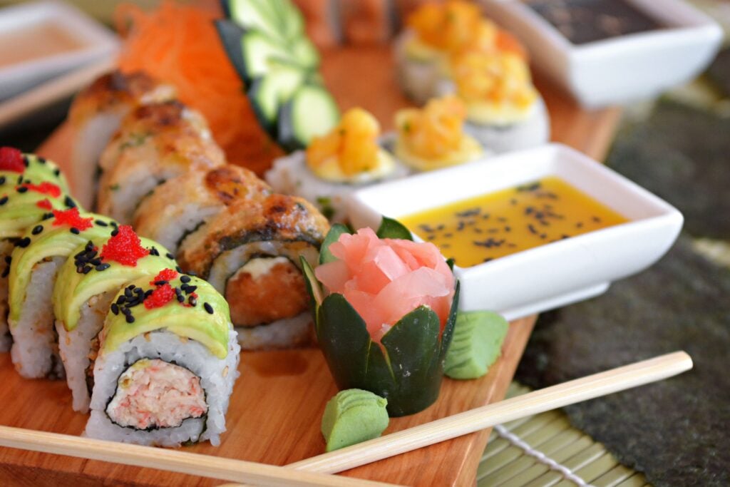 Assorted sushi and sashimi beautifully presented on a wooden serving tray in Tokyo, Japan.